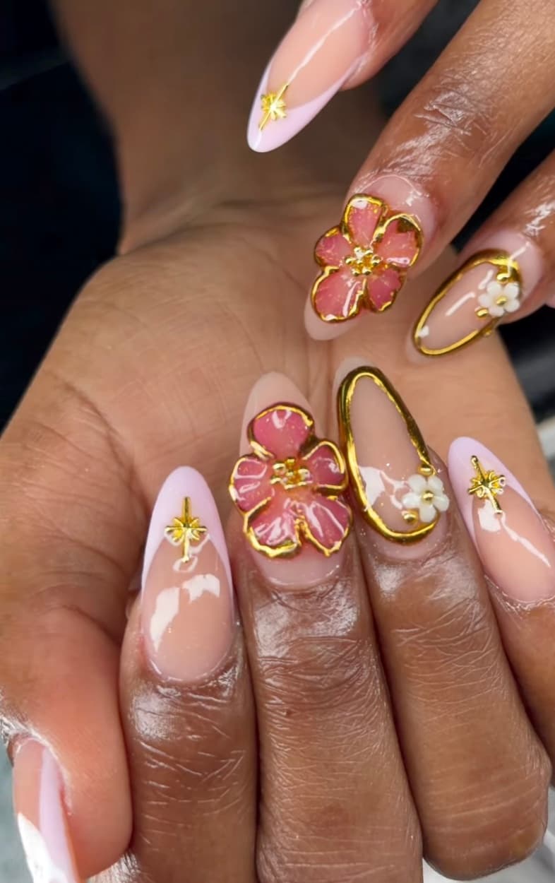 Pink 3D floral nail art with gold outline
